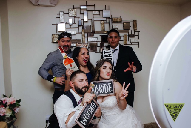 Open-air wedding photo booth with custom floral backdrop in Philly